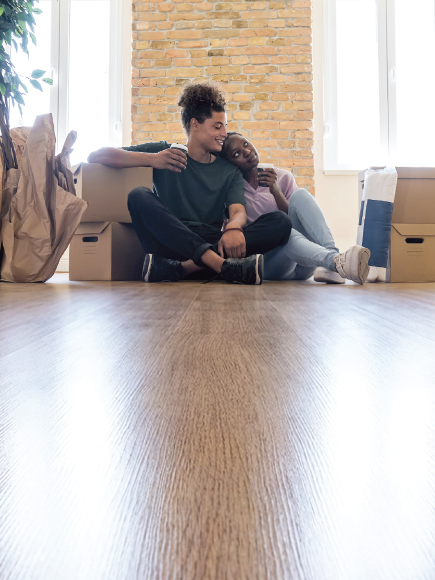 Family playing games in a living room with a hardwood floor