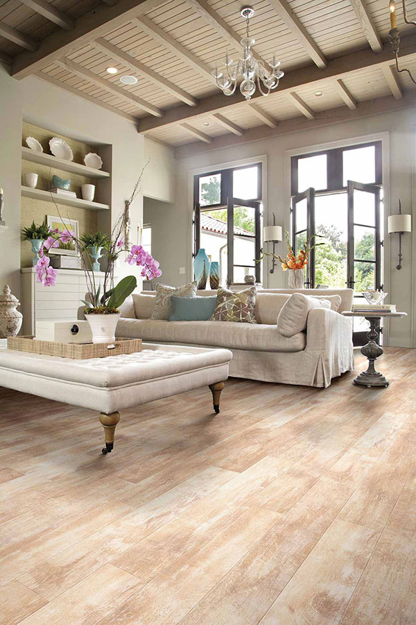 Large living space decorated with a cozy ottoman