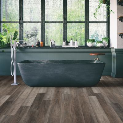 LVP Floors in a spa like Sarasota bathroom with green tub
